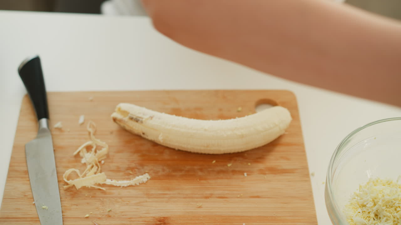 Preparing a banana for a dish