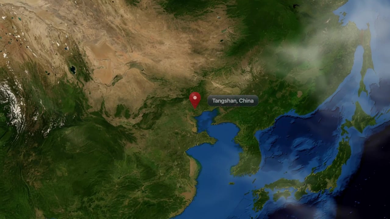Satellite view camera zooms in from outer space to Tangshan, China with location pin. Includes NASA public domain imagery.