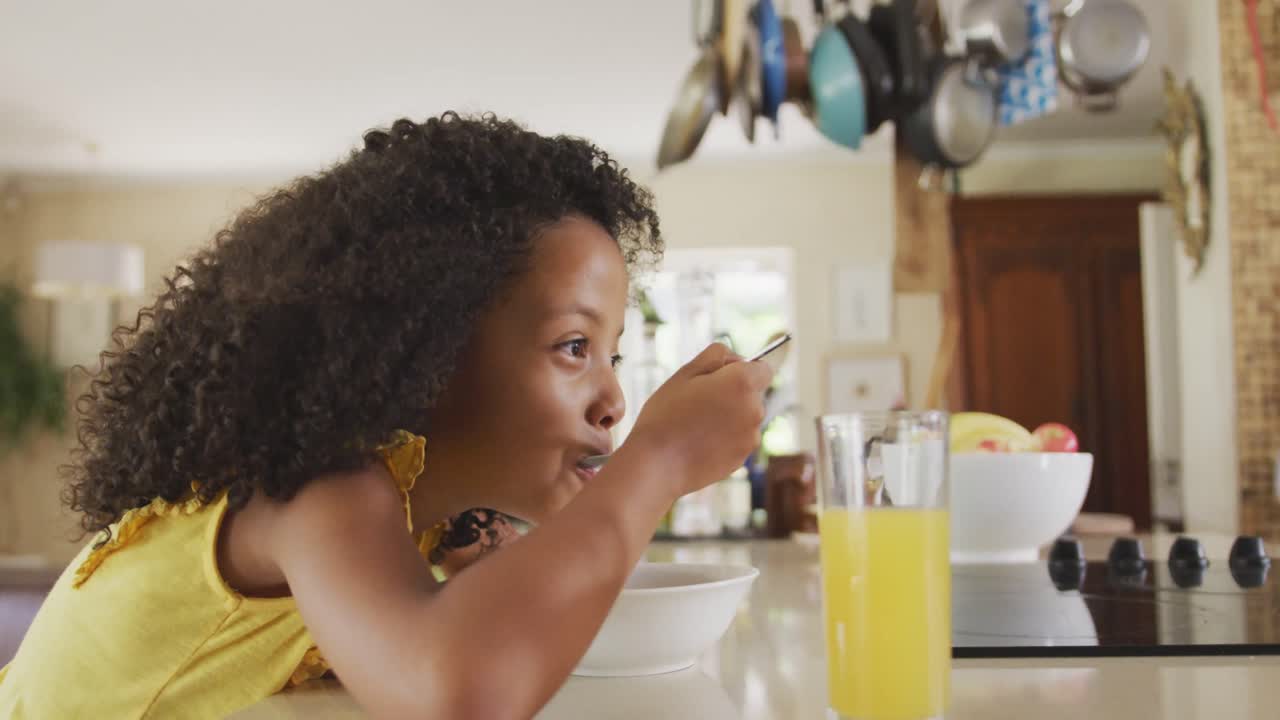 Side view of African american girl eating cereals