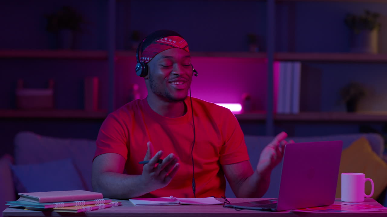 Man having an online study session at night