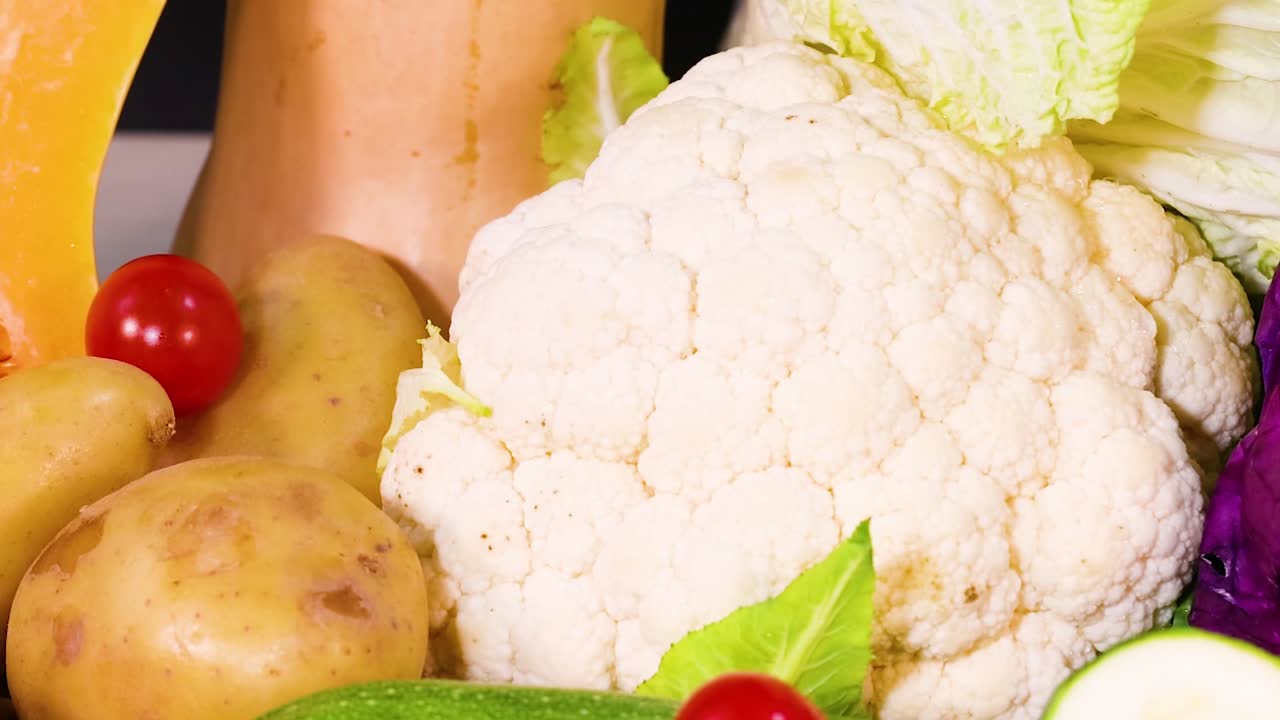 A colorful assortment of zucchini, radishes, potatoes, cauliflower, and cherry tomatoes on a vibrant platter.