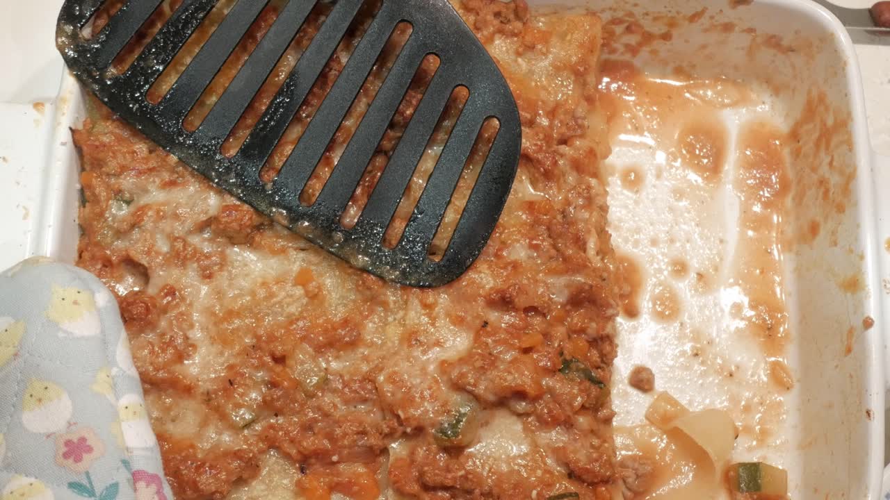 Delicious homemade lasagna with spatula, fresh from the oven