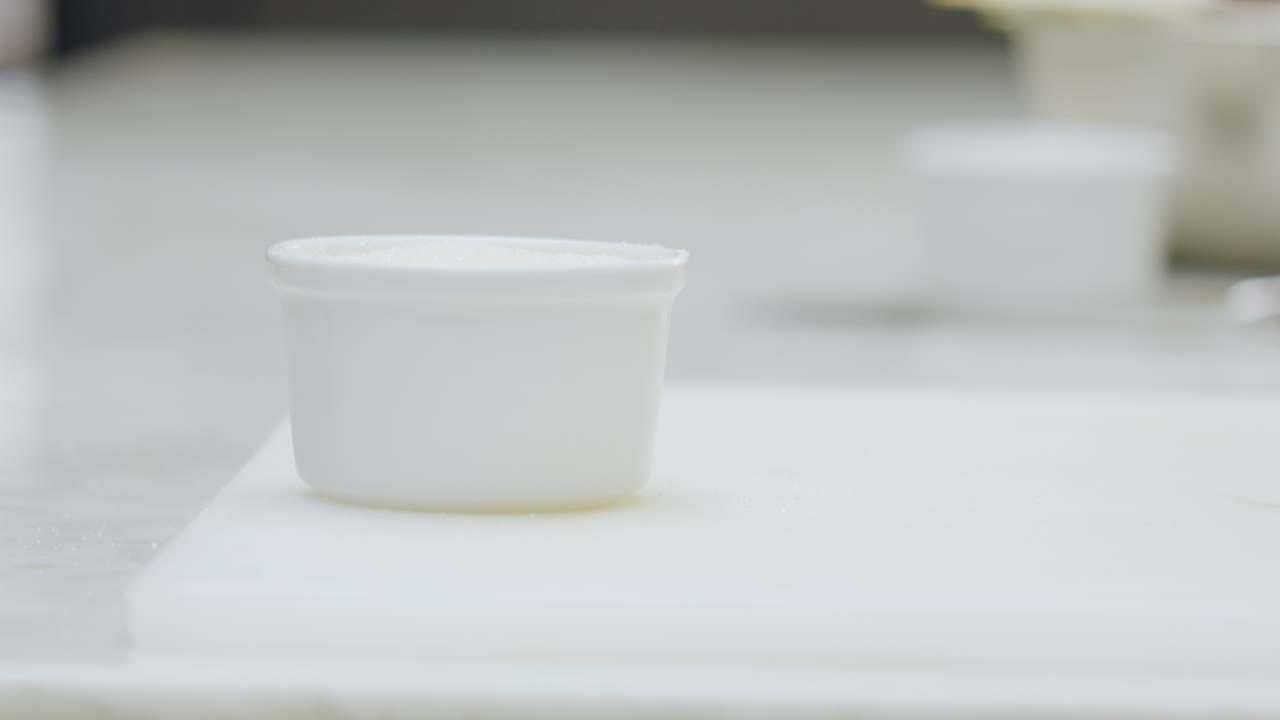 Close-up of a creme brulee dessert being torched with a culinary torch to caramelize its surface