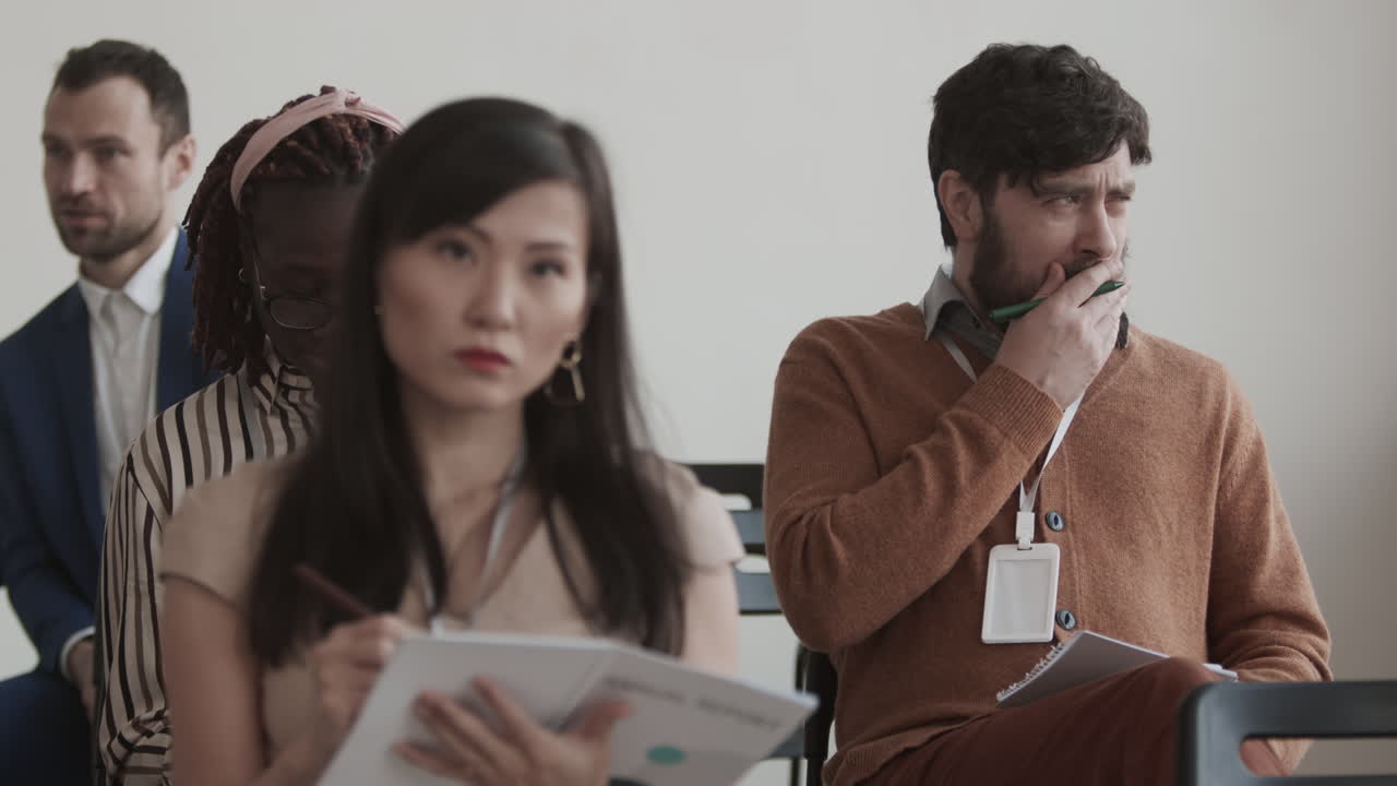 Caucasian Businessman Listening to Presentation Yawning