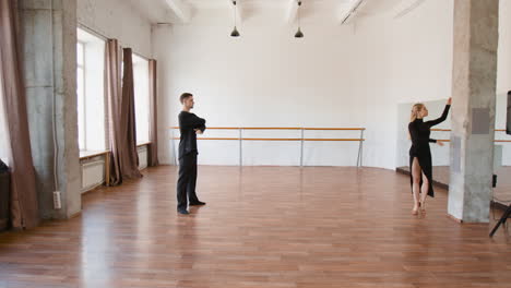 a couple practicing dance in a spacious studio