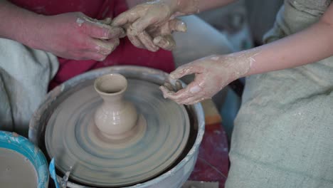 potter teaching pottery little girl