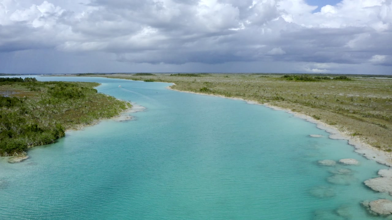 An stunning aerial drone shot showcases the famed Laguna de Bacalar, also known as the "Lagoon of Seven Colors," in Quintana Roo, Mexico.