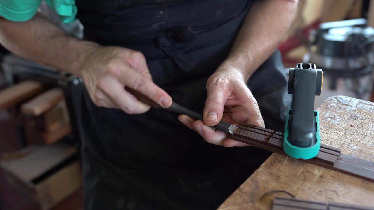 Spanish guitar maker or luthier working on a flamenco guitar