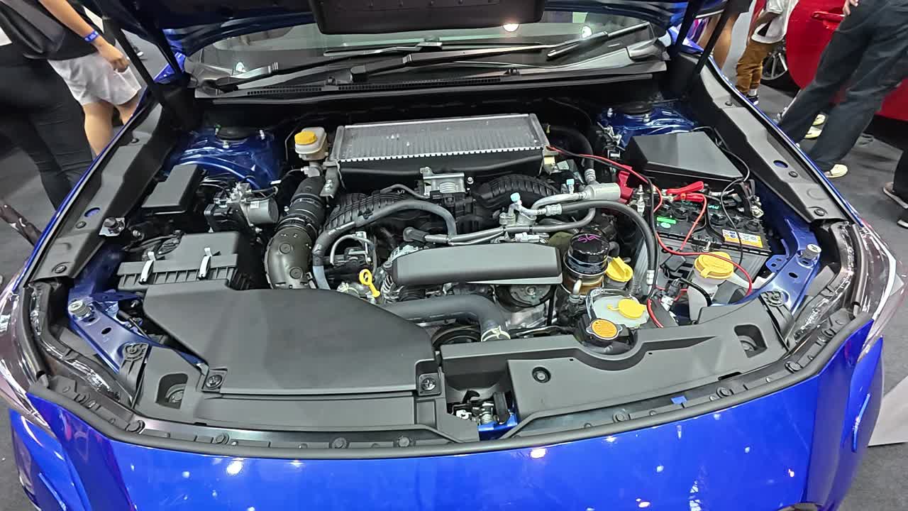 Newly revealed car engine in a showroom. The hood is open, showcasing the powerful engine to potential customers.