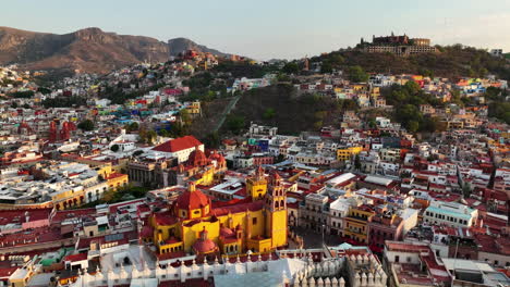 flying around the colorful skyline of guanajuato, sunset in mexico - aerial view