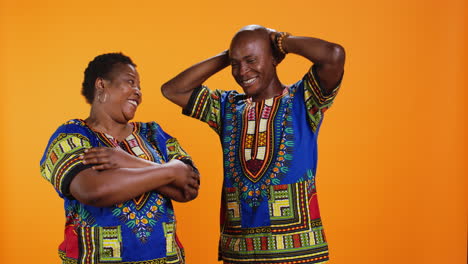 cheerful husband and wife laughing together on camera