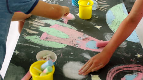 children creating art with chalk