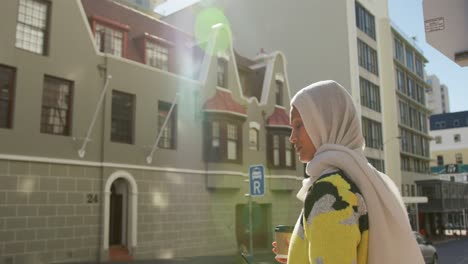 young woman wearing hijab out and about in the city