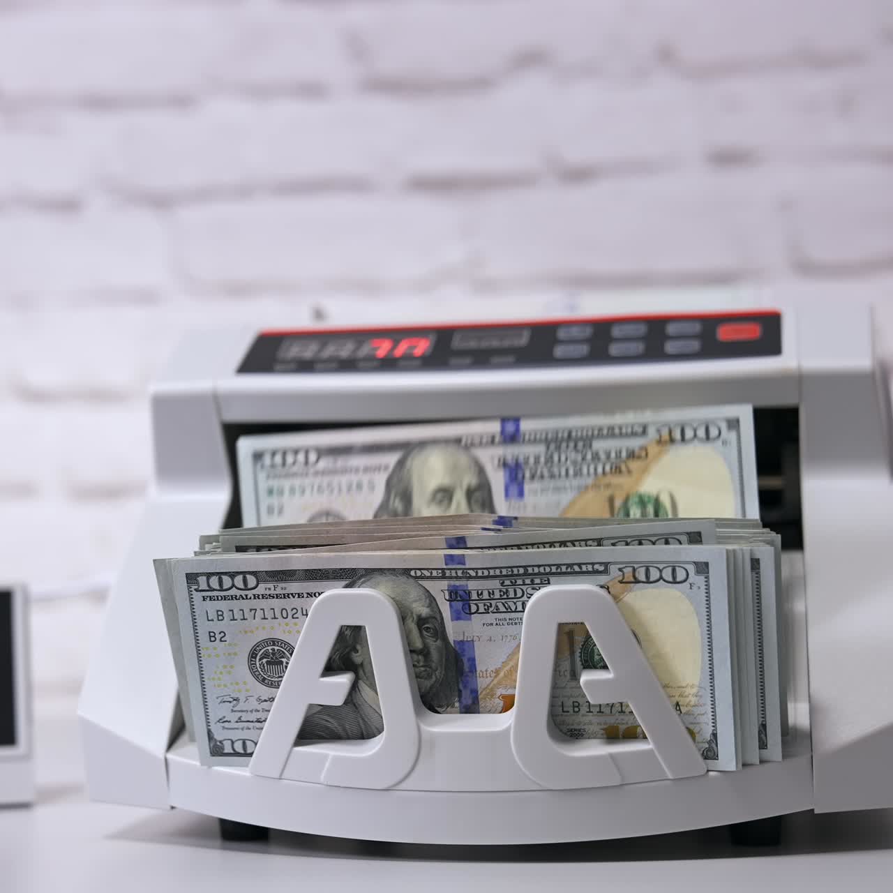 Money counting machine. Modern electronic bill counter with money, close up