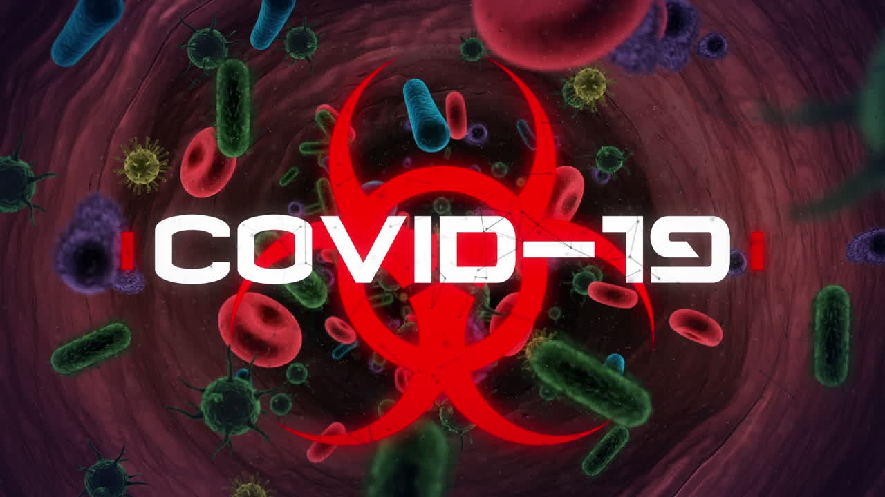 Covid-19 text over biohazard symbol against covid-19 cells and blood vessels floating