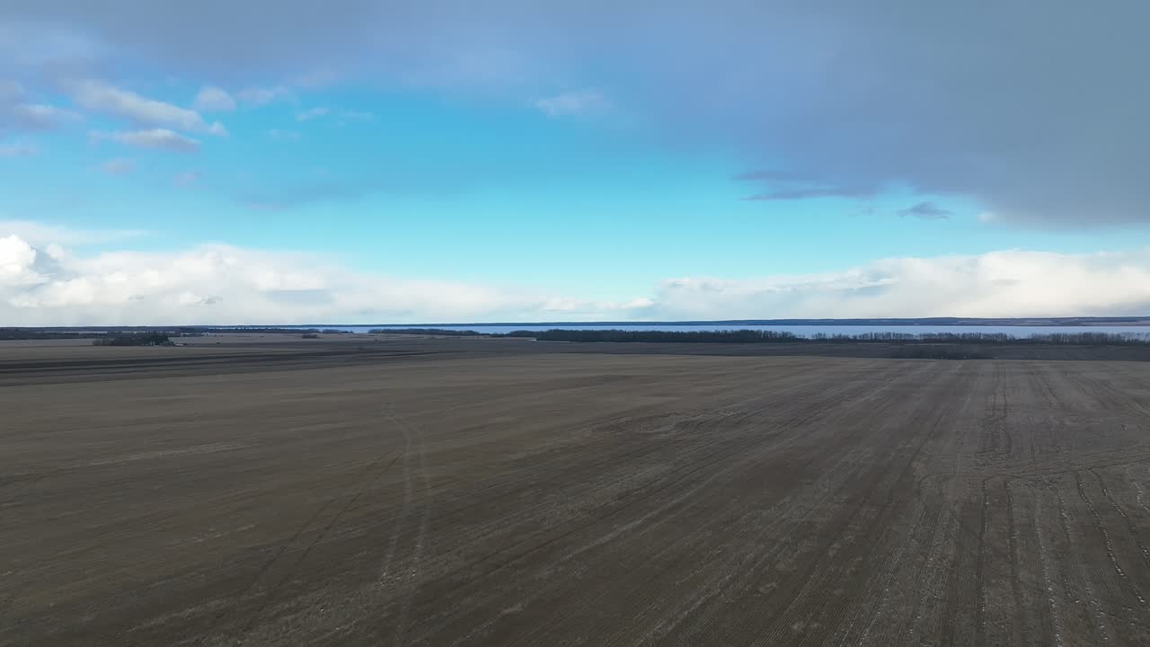 Aerial view of a harvested wheat field in the winter with no snow cover