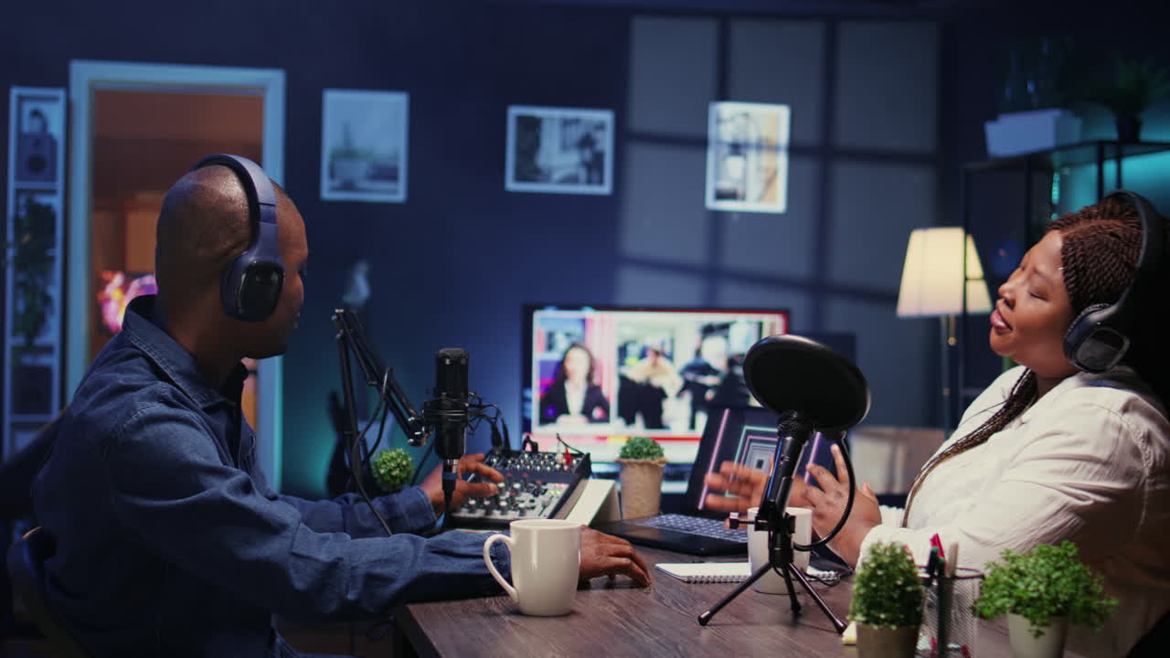 Show host recording podcast with guest, using analog mixer and professional mic in studio