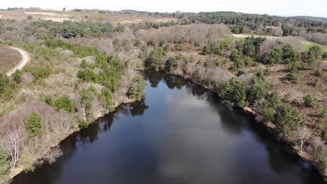 Aerial-View-Over-Squabmoor-Reservoir-Located-In-Woodbury-Common,-Devon