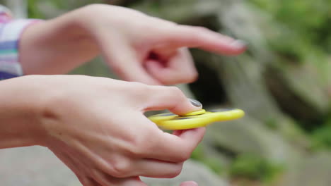 female hands play with a spinning toy video with shallow depth of field 4k video