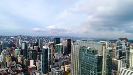 Rising-aerial-shot-of-Seattle's-skyline-with-the-Space-Needle-off-in-the-distance