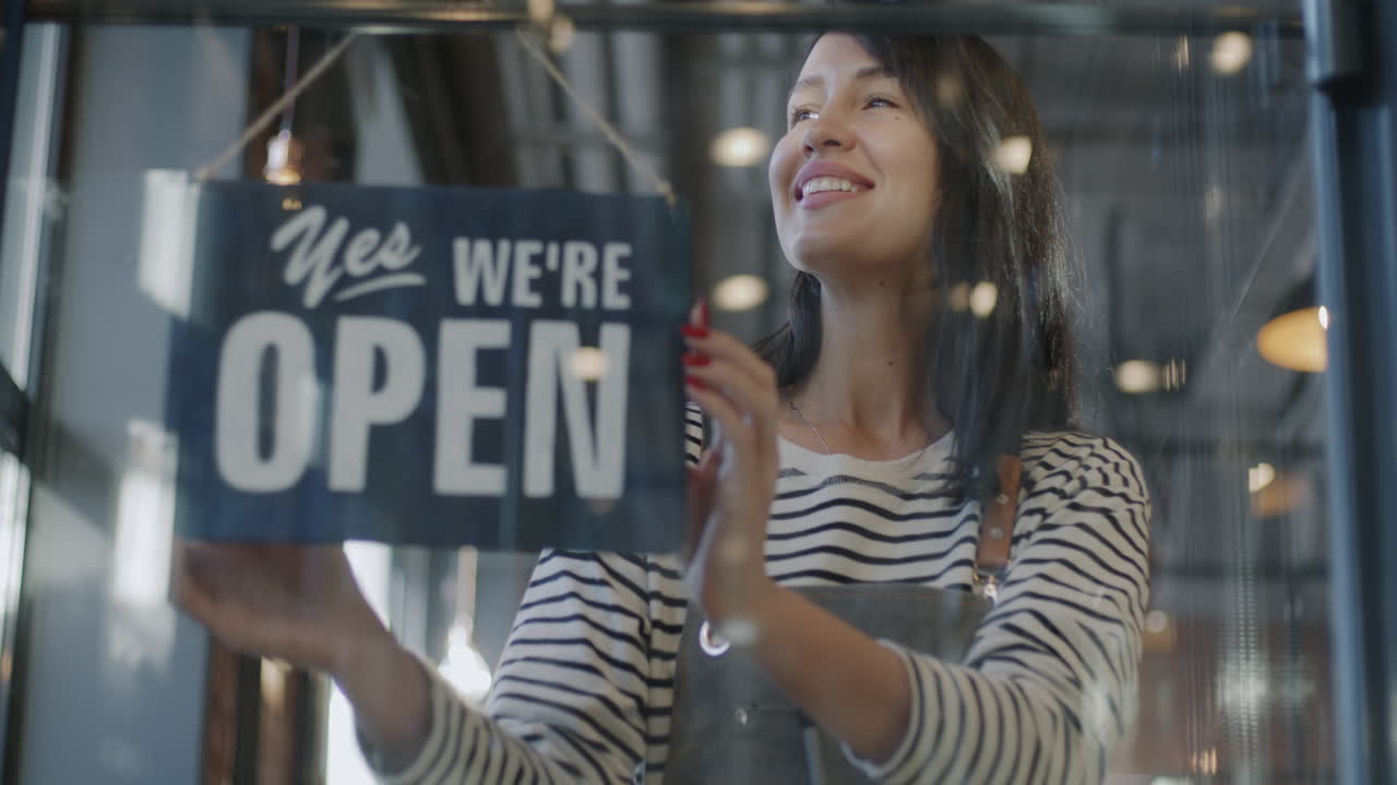 Woman Hanging Open/Closed Sign
