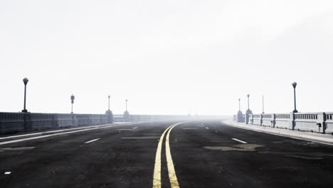 illuminated empty road bridge in a fog