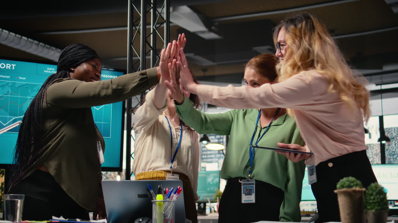 Vertical Video Group of corporate women working on data analysis and setting project goals