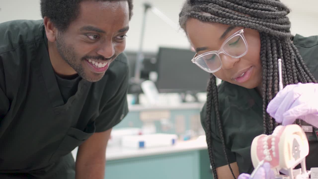 People working in a laboratory with dentures
