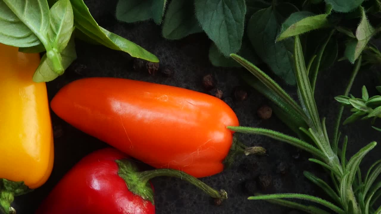 Making a vibrant Cajun Spice Blend, mixing red paprika, cayenne pepper, oregano, thyme, white garlic onion powder and black pepper in a bowl, creating a striking contrast against a black background.