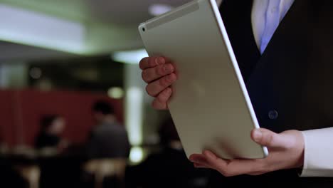 waiter holding a tablet in a restaurant