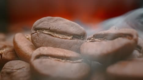 Close-up-of-seeds-of-coffee.-Fragrant-coffee-beans-are-roasted-smoke-comes-from-coffee-beans.