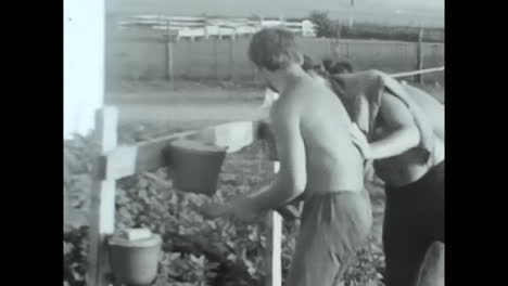 soviet union archive video, a men engaged in dirty work on the ground. circa ussr 1980s: an archive video from the soviet union depicting a men immersed in the dirt, diligently engaged in manual labor.