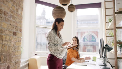 business woman using tablet app showing 3d printed model of geodesic dome walking through modern office to diverse team meeting
