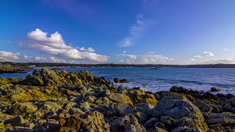 Panning-motionlapse-of-clouds-over-sea-and-rocky-coast-at-golden-hour