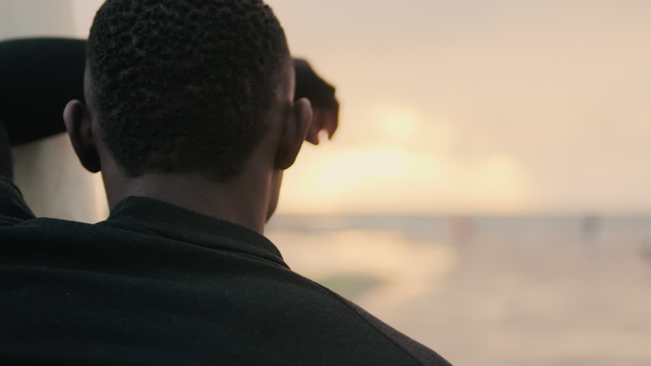 Man Contemplating Sunset Over Ocean
