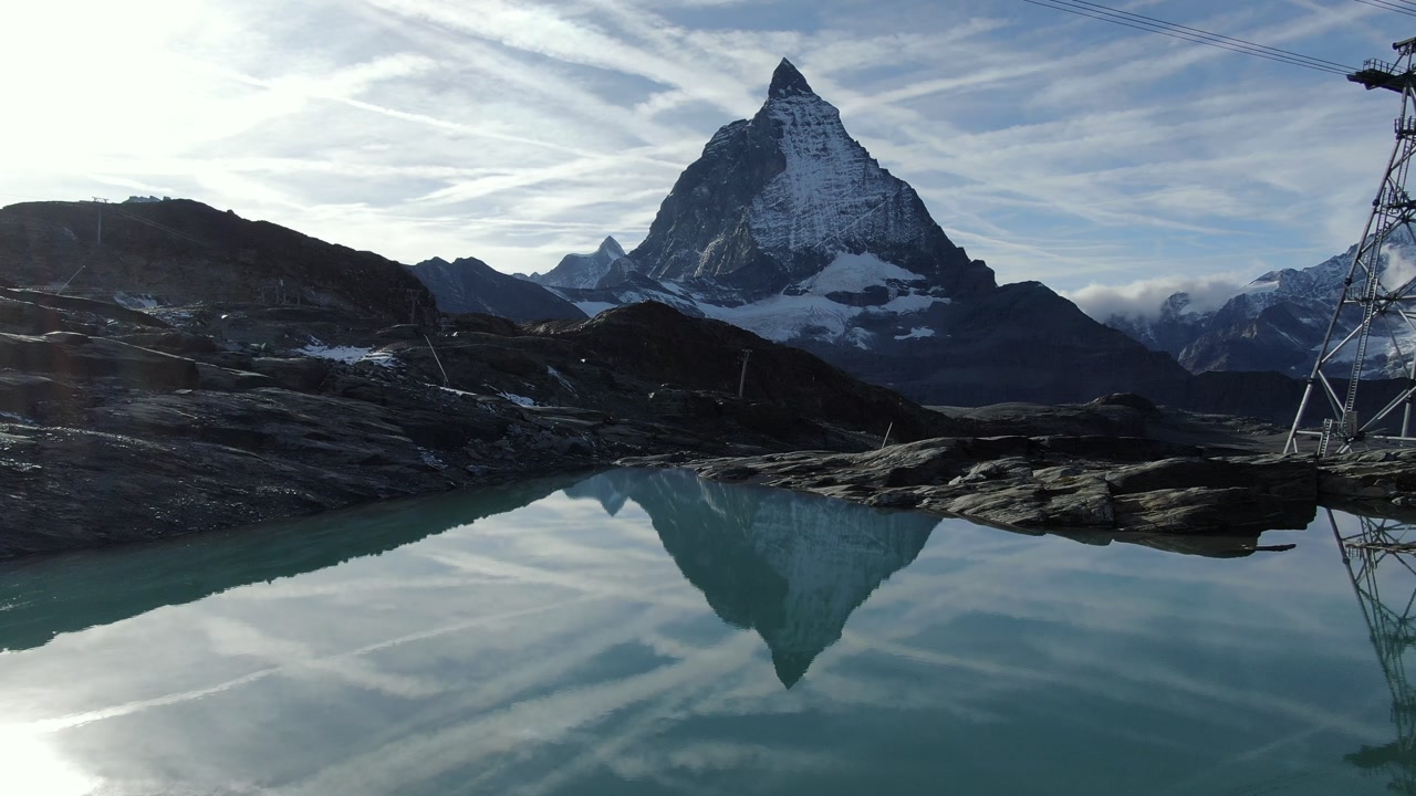 Matterhorn mountain in the Swiss Alps reflected in a small lake aerial drone Switzerland