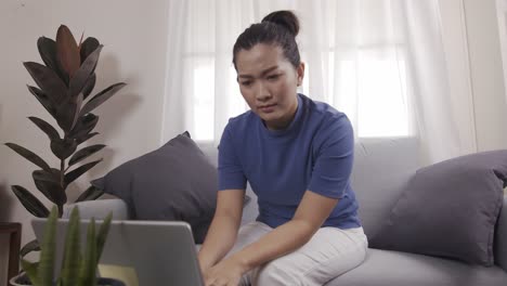Asian-businesswoman-are-using-cards-to-pay-for-online-shopping-on-a-laptop