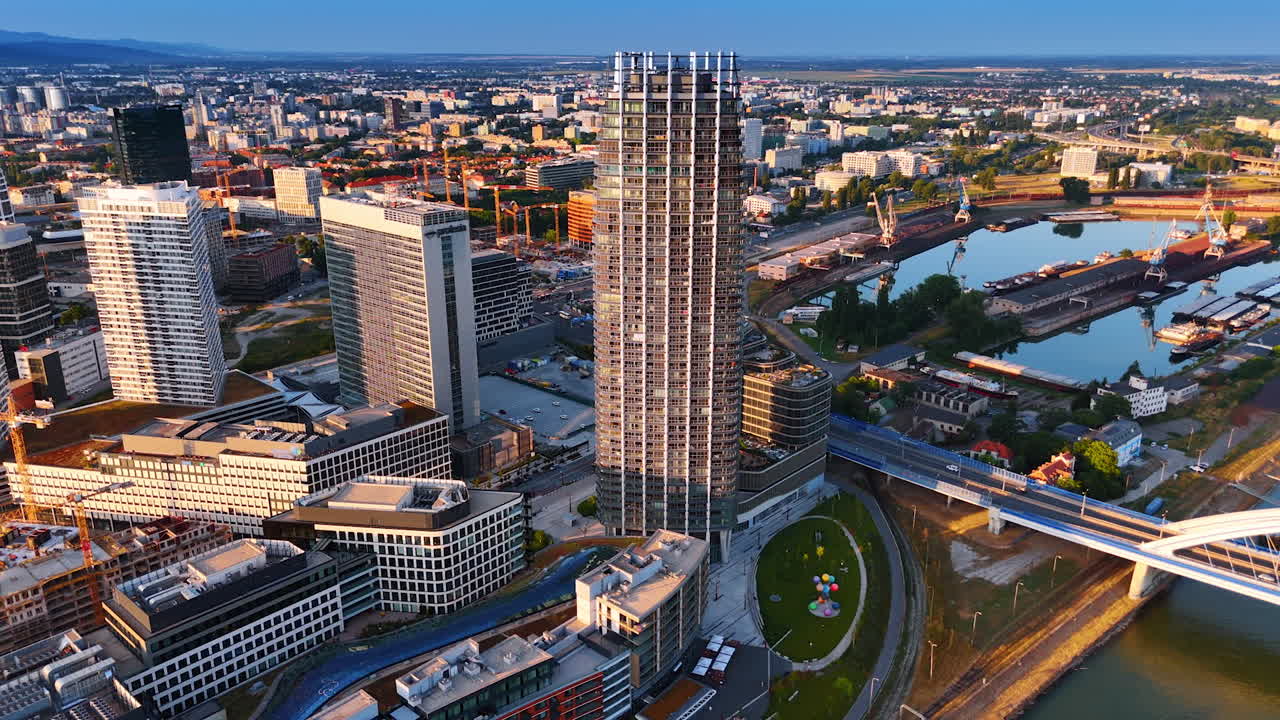 Bratislava, Slovakia - June 14, 2025: Sunset skyline: Bratislava views. A bustling European cityscape of Bratislava showcases modern architecture and a serene waterfront at sunset