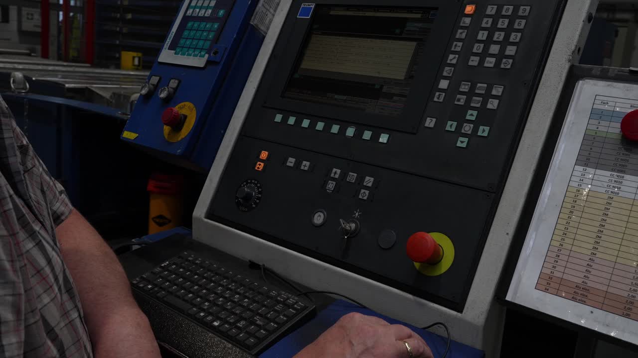 Industrial machine control panel operated during automated manufacturing process, focused on digital controls, precise input, system monitoring and efficient production management