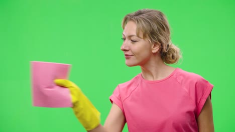 woman cleaning with pink cloth and yellow gloves