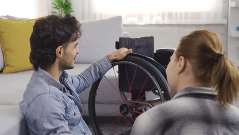 disabled man and his girlfriend are having fun at home.