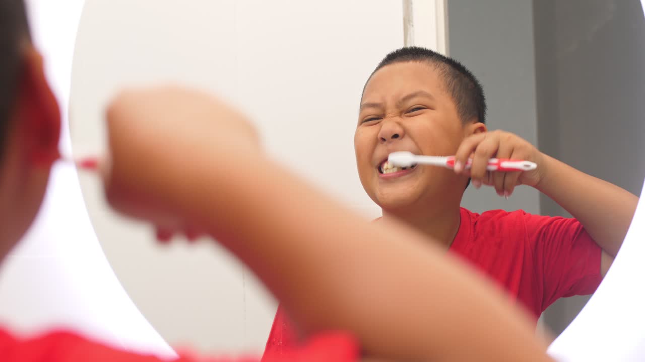 Asian Boy Brushes Teeth