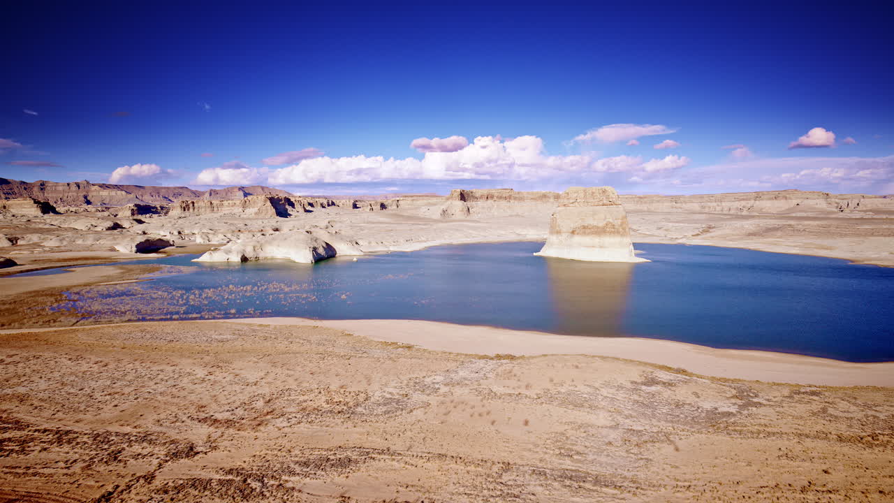 A drone glides toward striking rock formations near Lake Powell in Page, Arizona.
