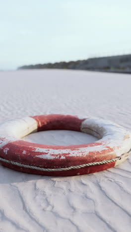 vintage life preserver on sandy beach