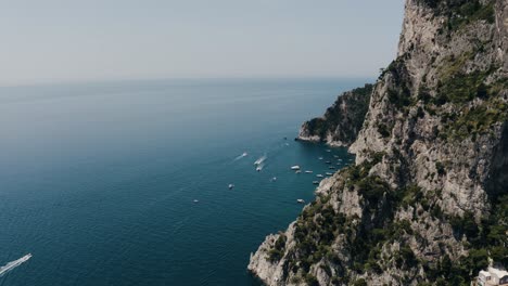 Aerial-view-of-Capri,-Italy's-steep-cliffs-leading-to-lower-beaches