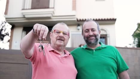 happy homeowners in front of new house with keys
