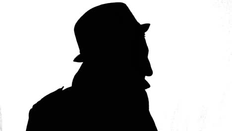 homme mystérieux en manteau et chapeau tournant autour, silhouette noire sur fond blanc