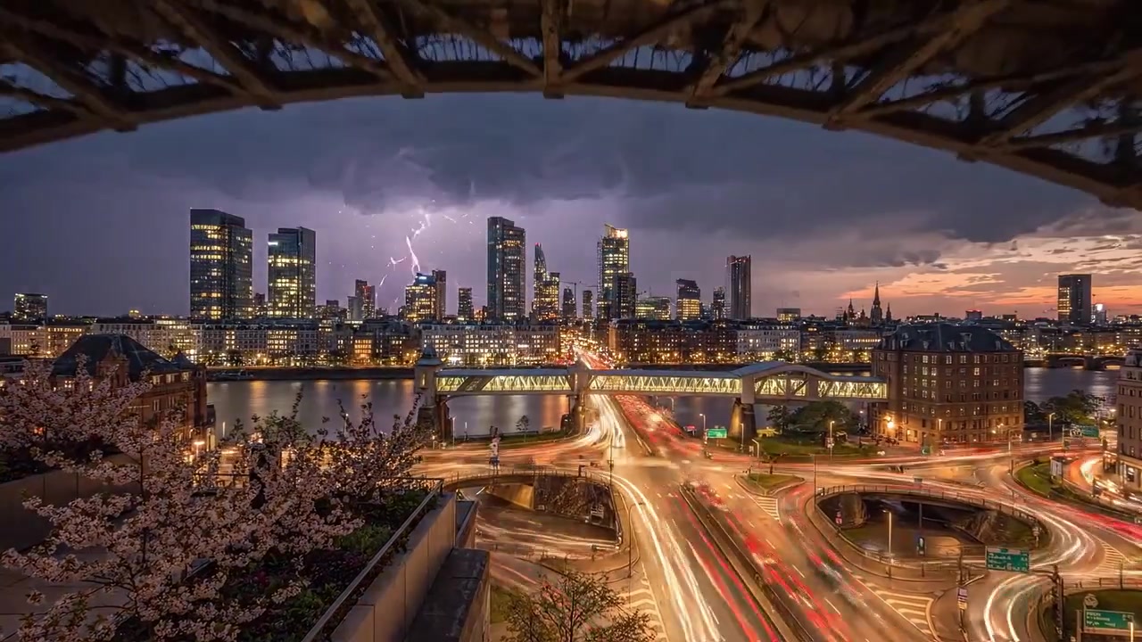 Dramatic Evening Skyline with Lightning Above a Vibrant Cityscape, Showcasing Bridges, Light Trails, and Towering Buildings Enhanced by a Thunderstorm