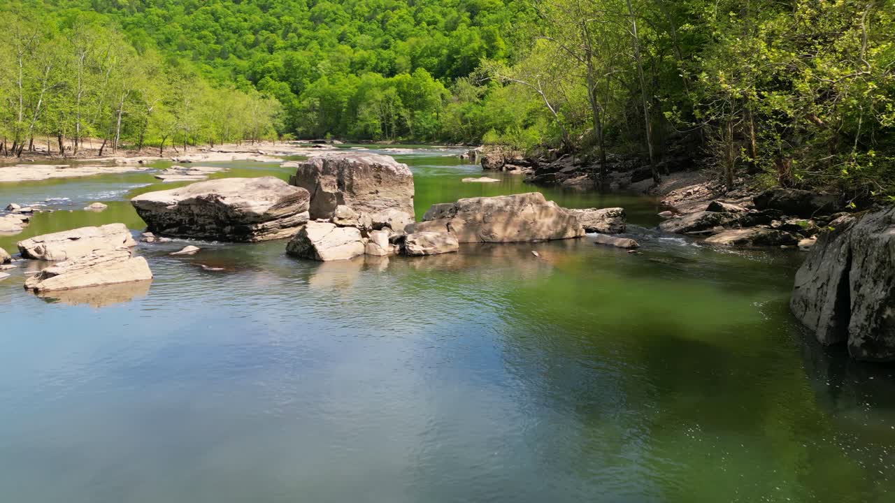 Aerial flyover large boulders along river, West Virginia
