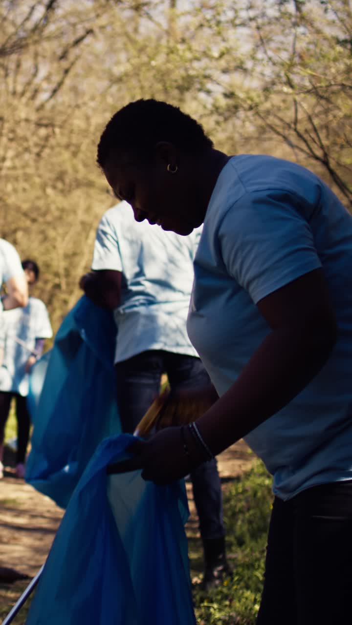 Volunteers Cleaning Up Litter in a Park on a Sunny Day